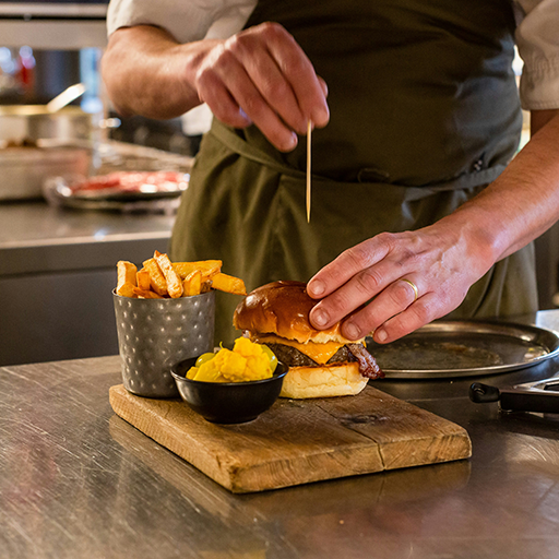 Chef grilling smash burgers
